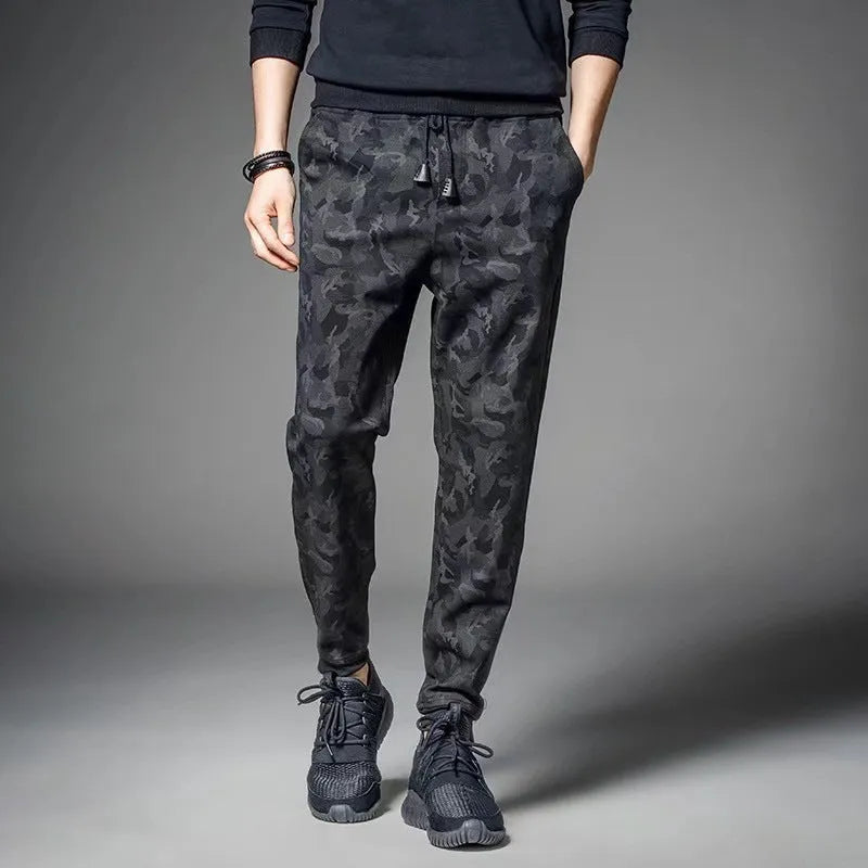 Men's black jogging pants made from acetate and modal fabric, side view on model