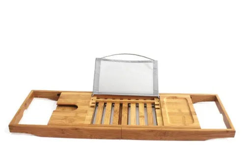 Natural bamboo single-tier desktop shelf for bathroom storage on a bathtub ledge.