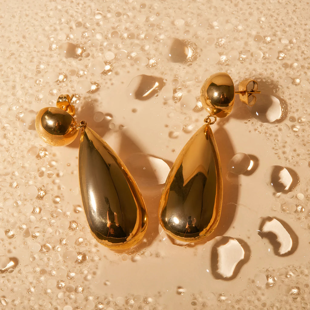 Gold coloured stainless steel earrings with a geometric shape and water drop pendant.