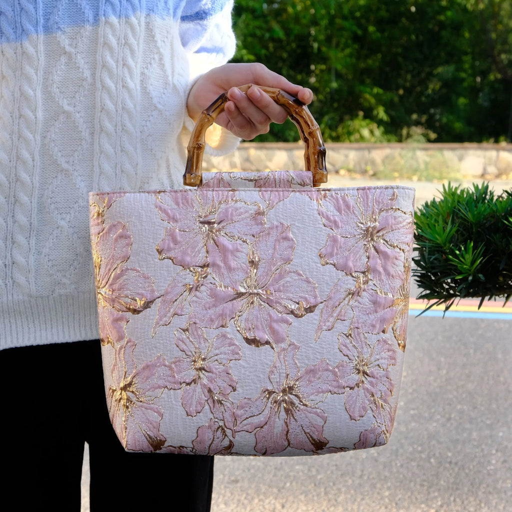 Light blue women's canvas shoulder bag with gold bronzing flower detailing showing horizontal square shape