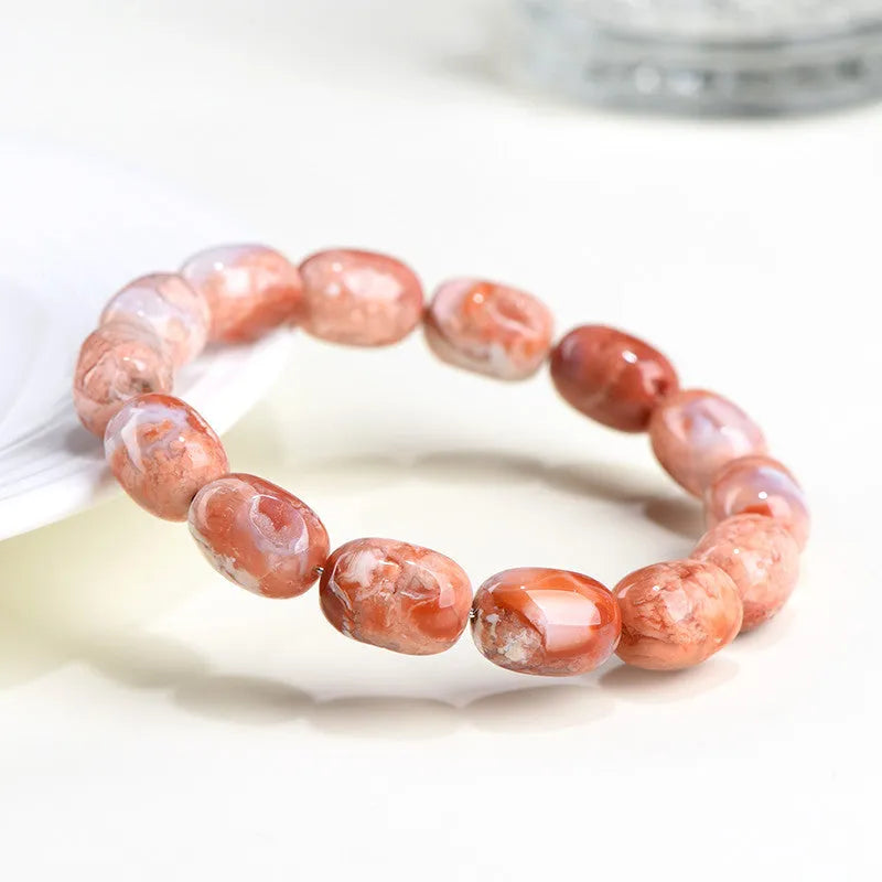 Natural cherry agate barrel bead bracelet with Ruyi charm showing 10x14mm beads
