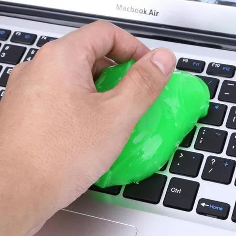 Blue and yellow magic cleaning gel putty for dust removal on a keyboard