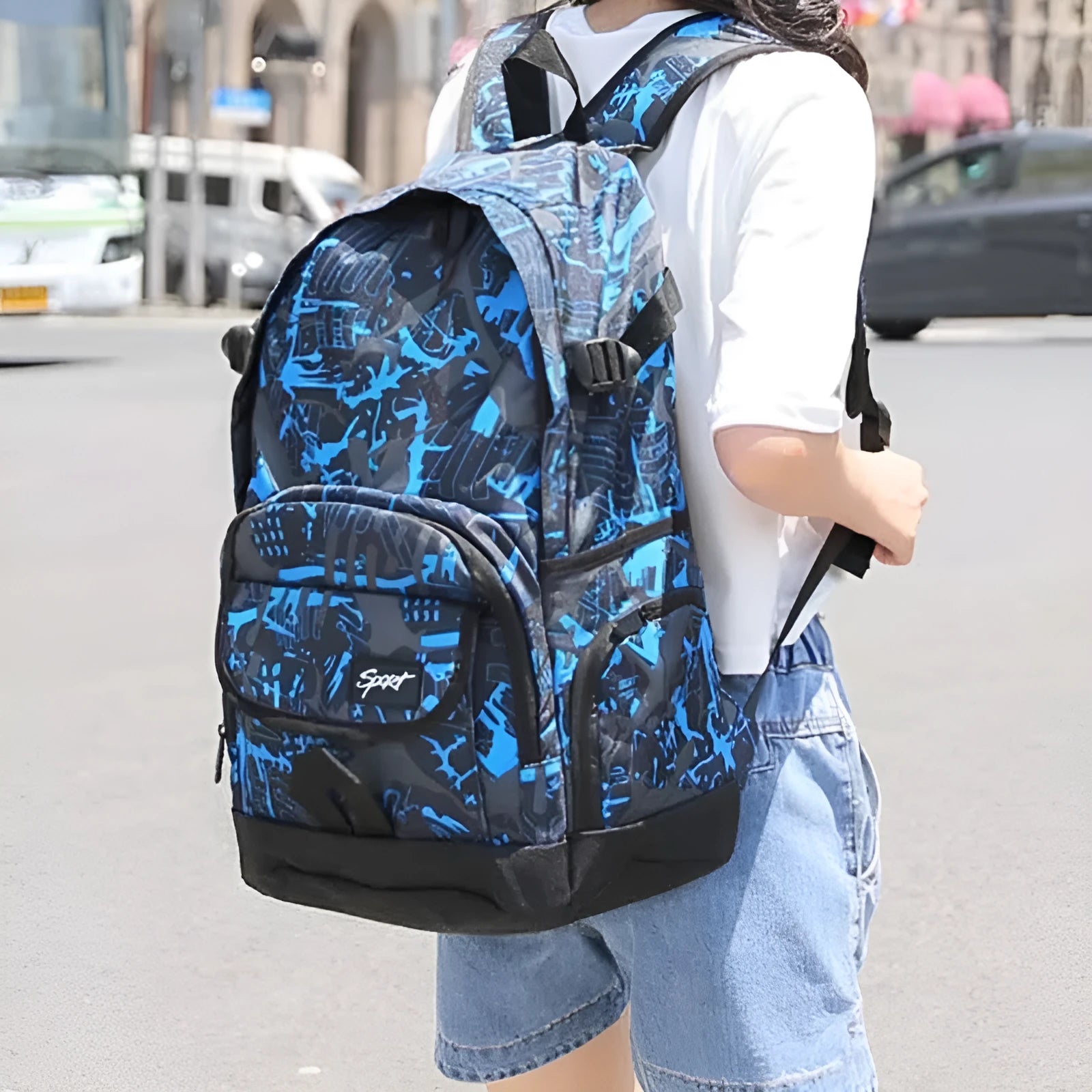 A classic blue or red nylon backpack with a large main compartment and multiple organiser pockets.