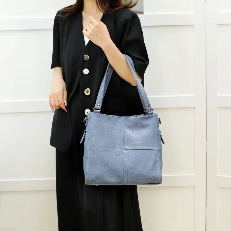 Barrel-shaped crossbody handbag in soft PU leather measuring 30 by 31.5 centimetres