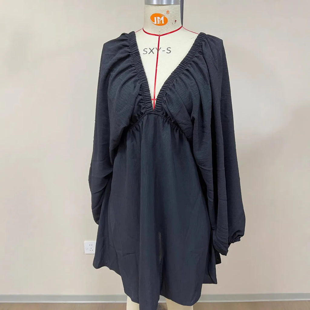 Women's apricot V-neck dress with long puff sleeves and a flounced swing skirt, mid-waist fit.