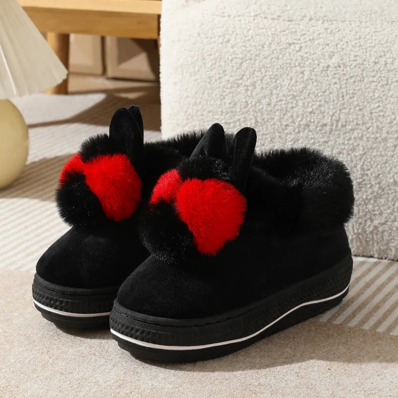 Grey plush high-heel winter slippers with a thick TPR sole on a wooden floor.
