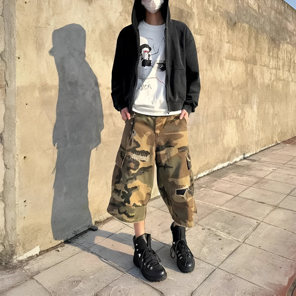 Men's loose-fit camouflage coloured cropped jeans with ripped details and straight-leg cut.