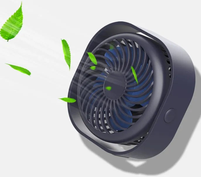 Pink USB desk fan with 360-degree rotating head on a white desk.