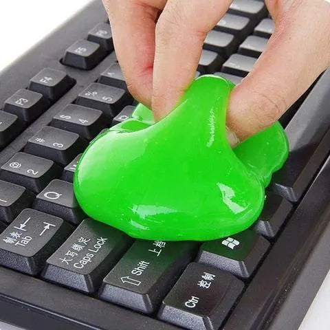 Blue and yellow magic cleaning gel putty for dust removal on a keyboard