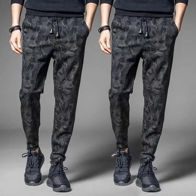 Men's black jogging pants made from acetate and modal fabric, side view on model