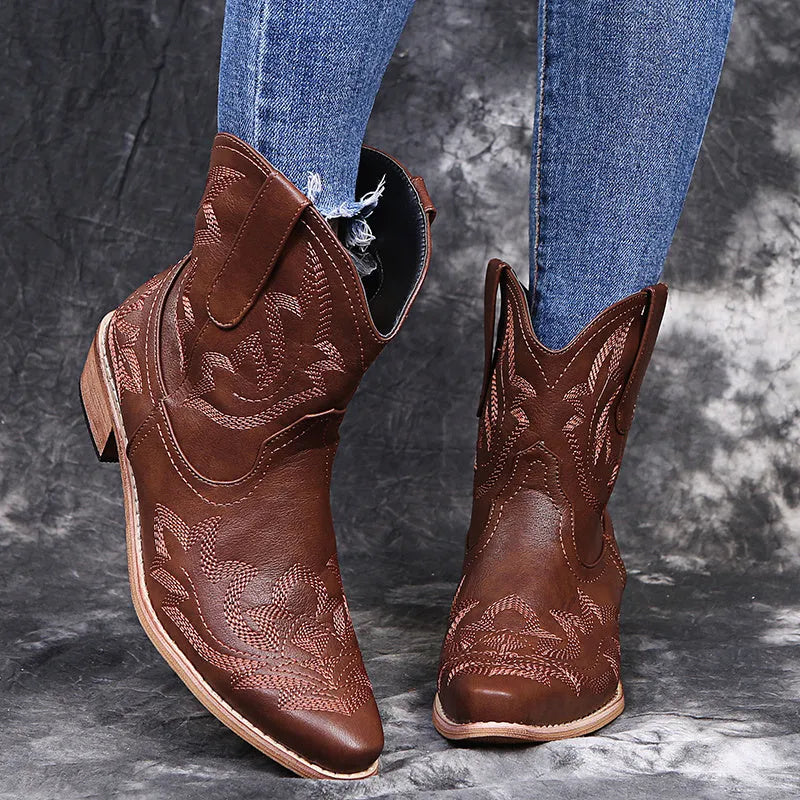 Women's blue embroidered cowboy boots with a low wedge heel and pointed toe.