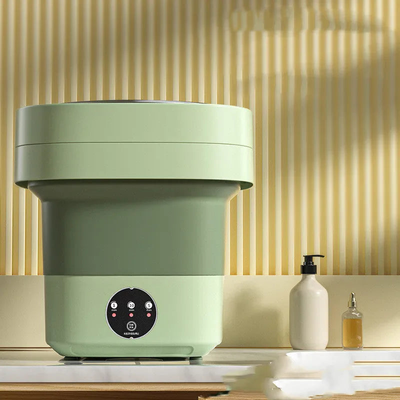 Foldable portable mini washing machine in green colour with drain pipe and basket