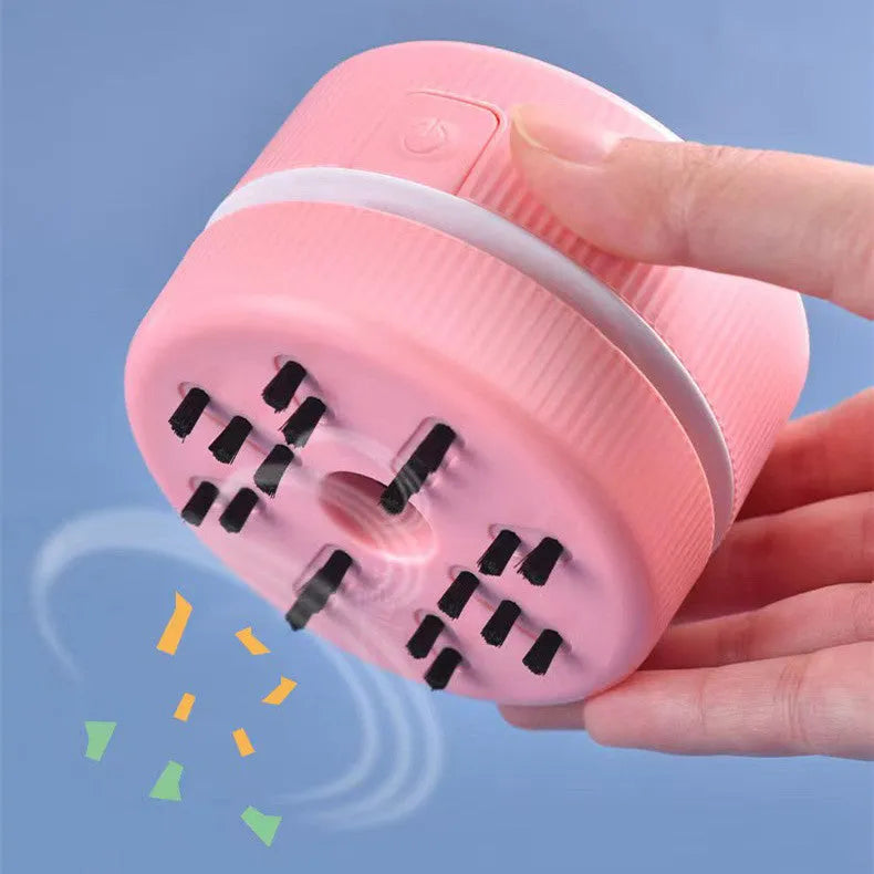 Portable mini desktop vacuum cleaner in blue and pink colour options with rechargeable battery