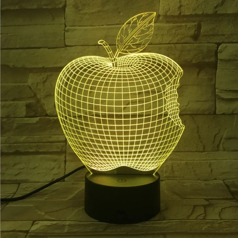 Colourful 3D fruit-shaped acrylic LED night light with touch controls on a dark surface.