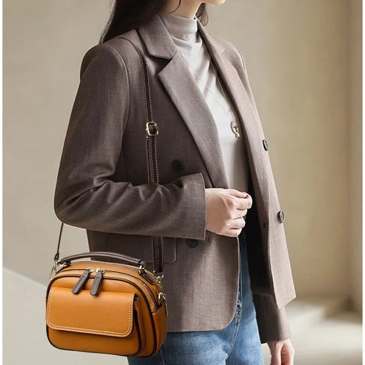 Women's black PU cross-body shoulder bag showing square shape and double connector straps