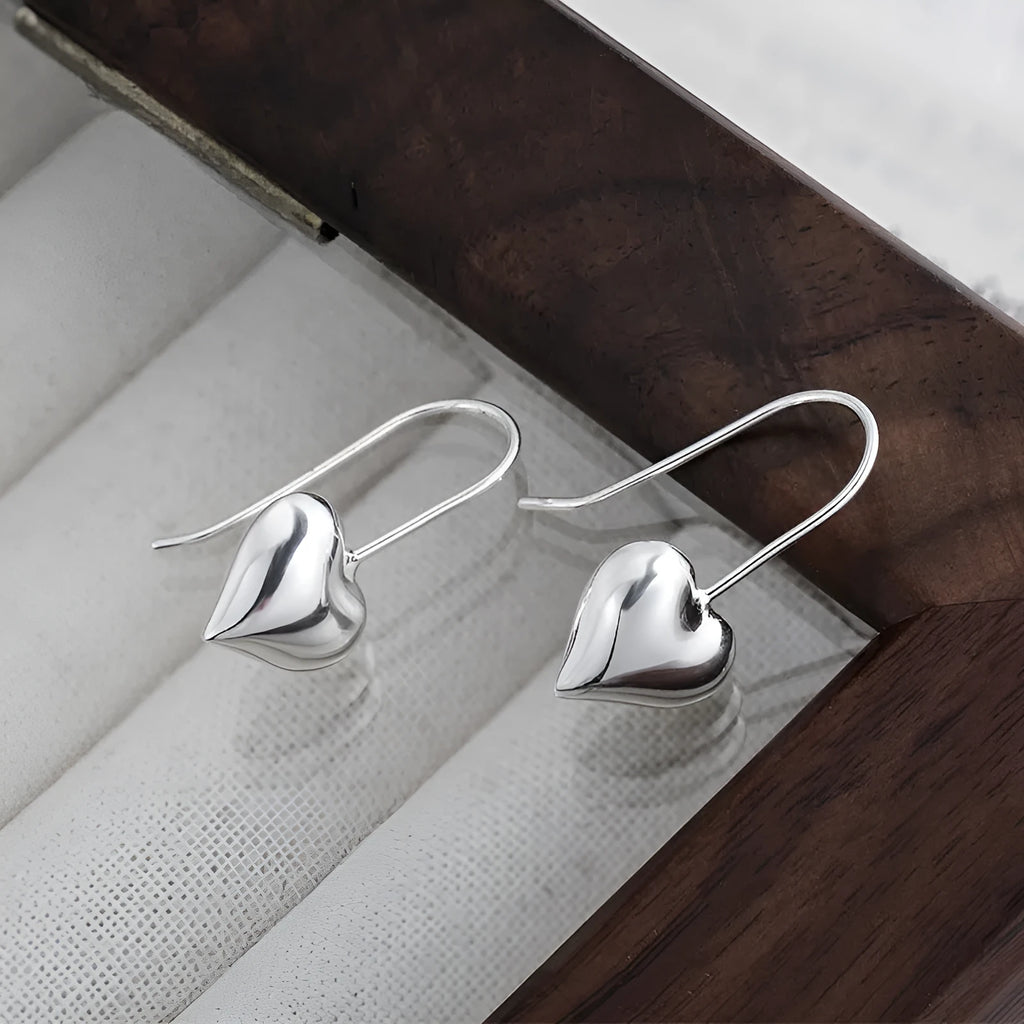 Three-dimensional glossy heart earrings with Korean style design in silver tone