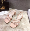 Women's white Roman sandals with a thick block heel over 8cm high, showing open back and side perforations.