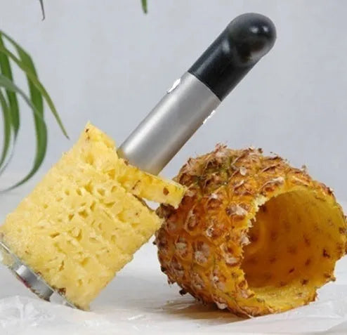 Stainless steel pineapple corer slicer with ABS handle showing pineapple preparation