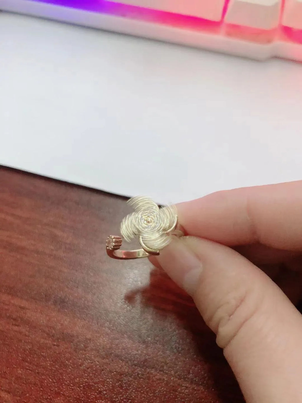 Women's geometric rotating ring with gold electroplated finish and circular decorative elements