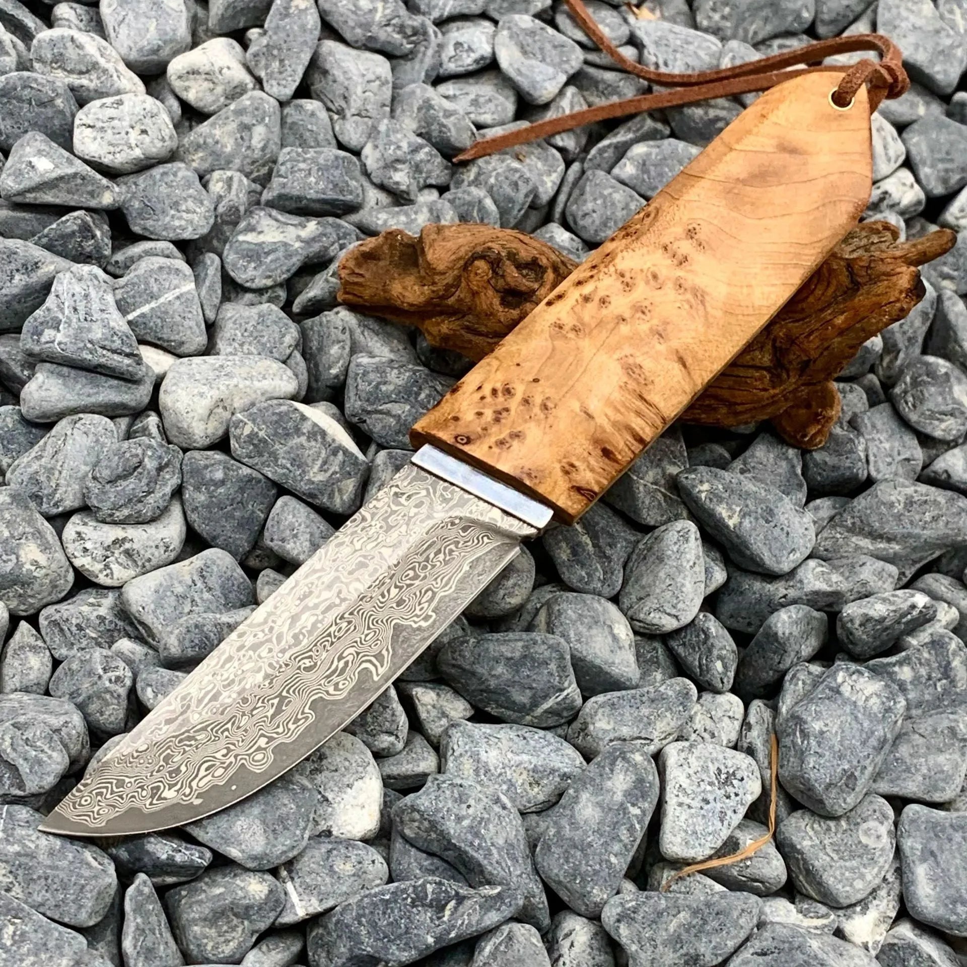 White Shadow Damascus pattern camping knife with Thuja wood handle, showing full 18cm length.