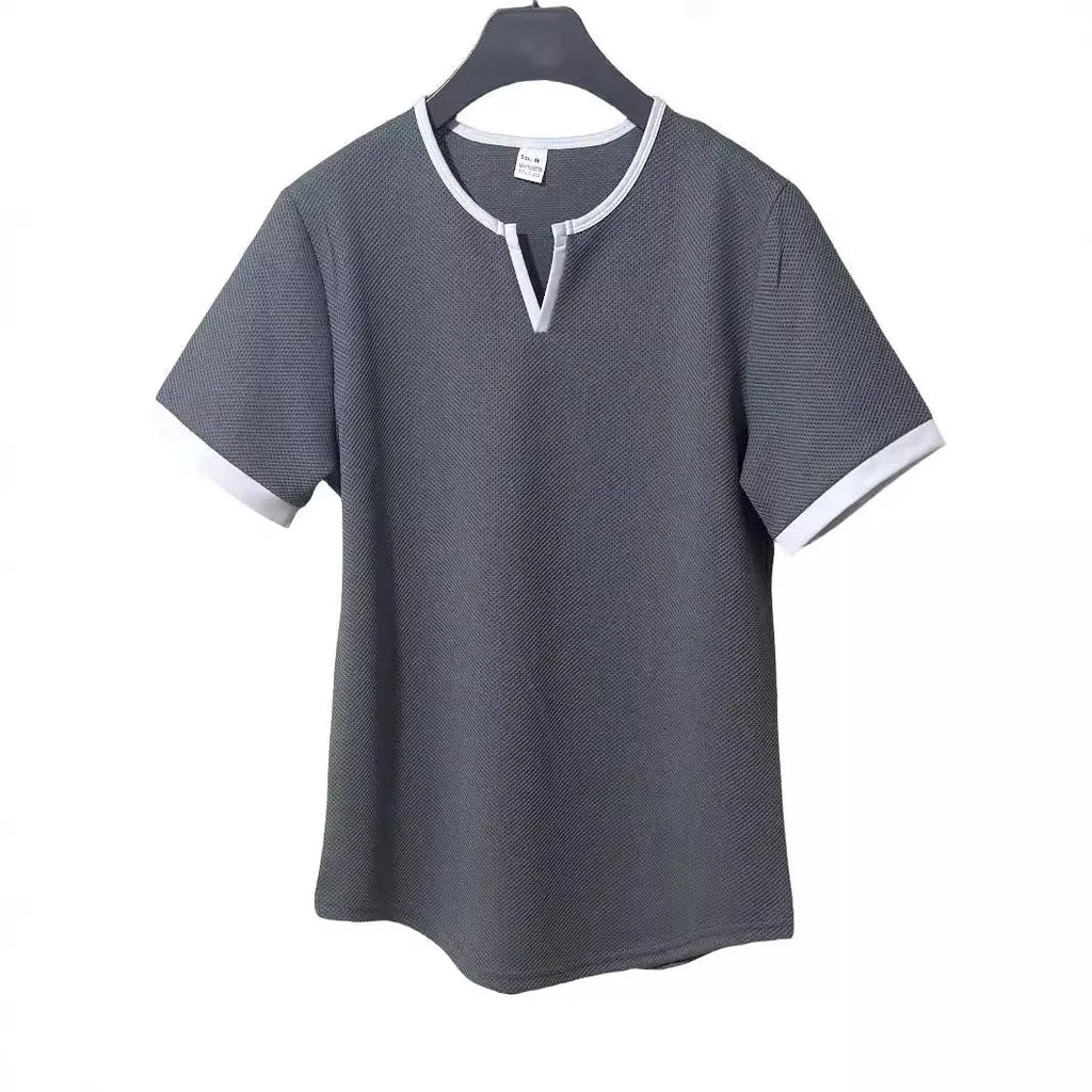Man wearing a grey and white colour-block V-neck waffle knit short sleeve T-shirt.