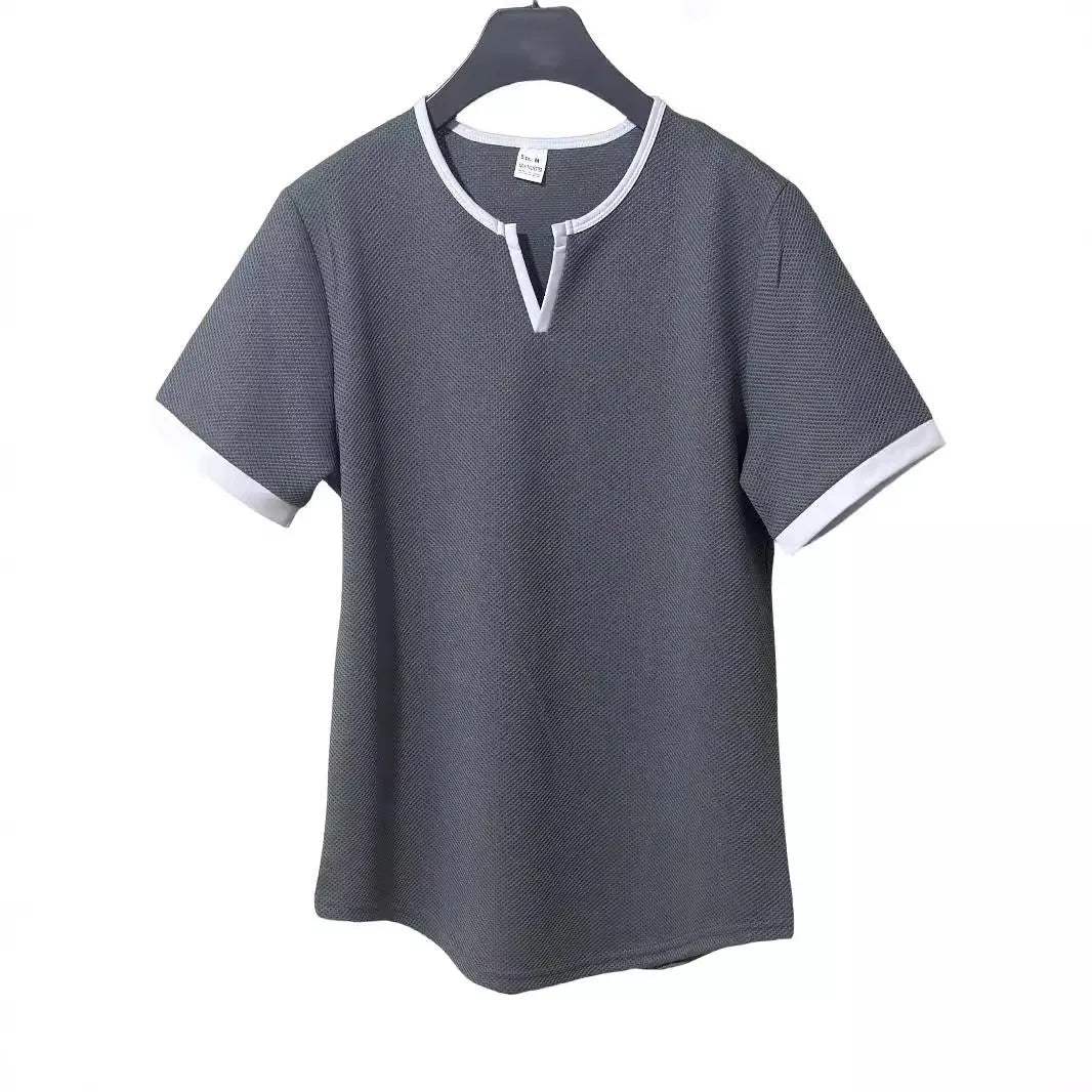 Man wearing a grey and white colour-block V-neck waffle knit short sleeve T-shirt.