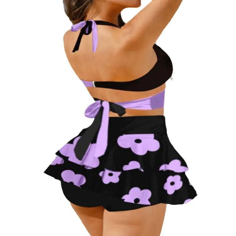 Purple high-waist bikini with matching skirt and lace-up back detail