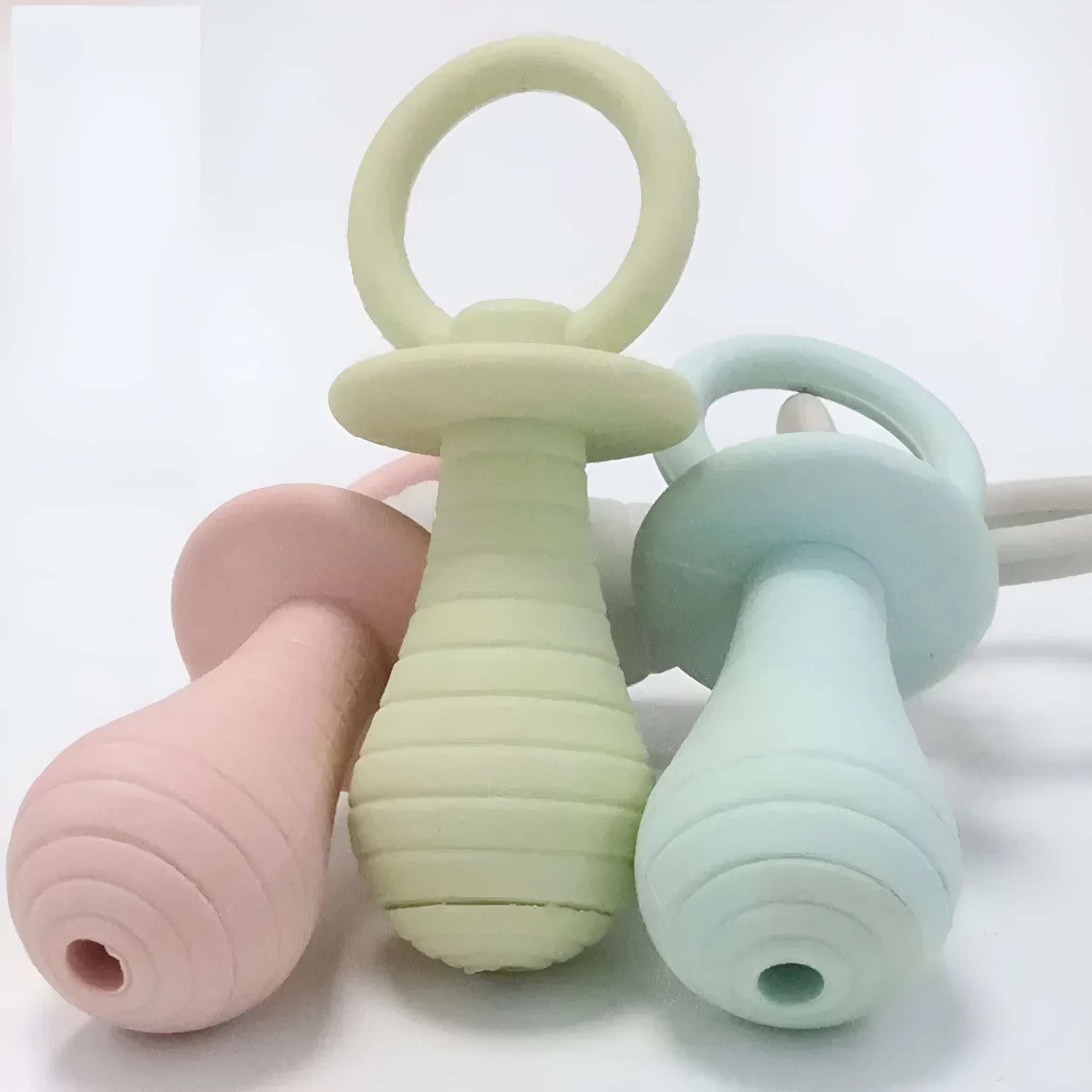 TPR pet pacifier squeaker toys for puppies and kittens in blue, grey, green, and pink colours