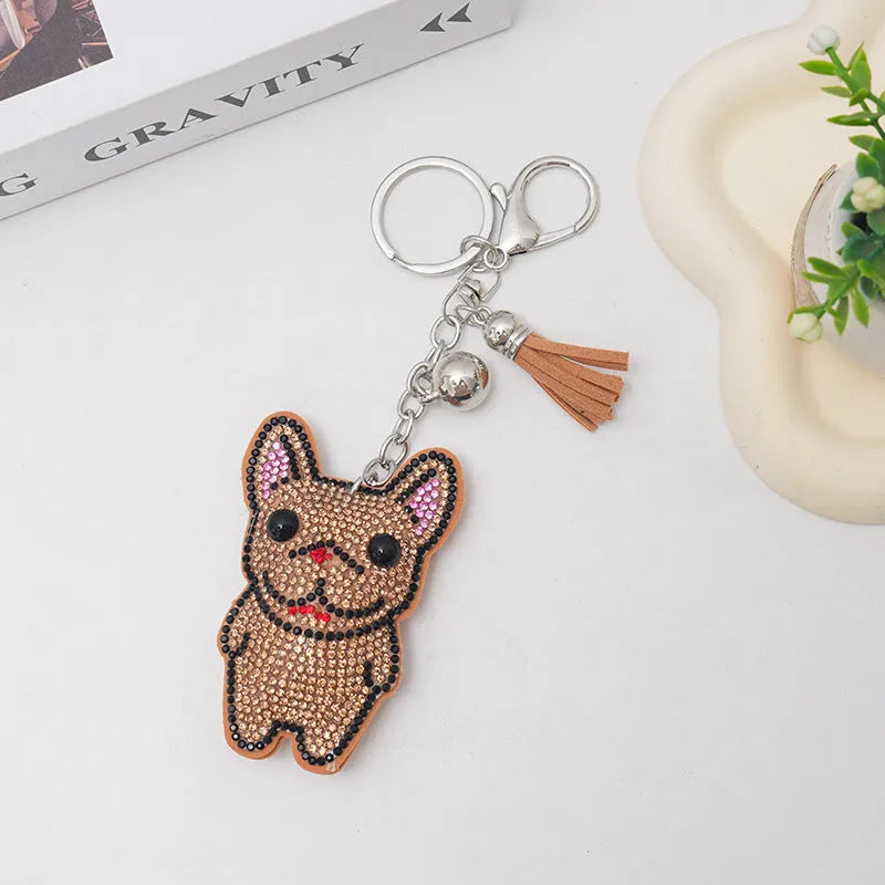 Close-up of a sparkling cartoon dog keychain pendant with rhinestones on an alloy base.