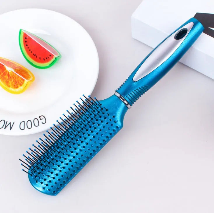 Pink electric ionic hair comb with ergonomic design on white background