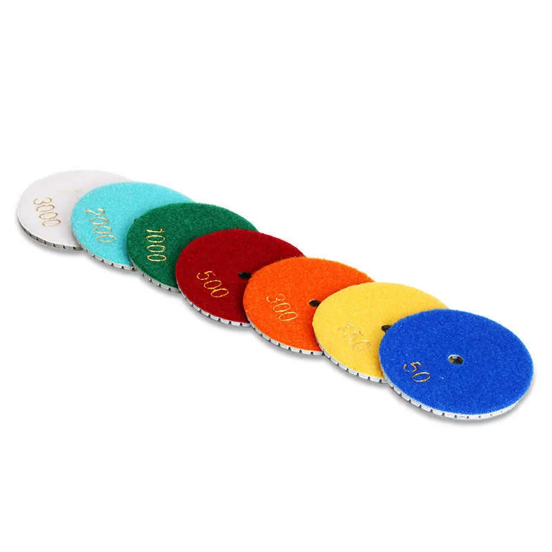 Set of 10 emery stone polishing pads showing 80mm diameter discs with central mounting holes