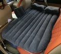 Universal inflatable car bed with flocked surface, shown with two pillows inside a vehicle.