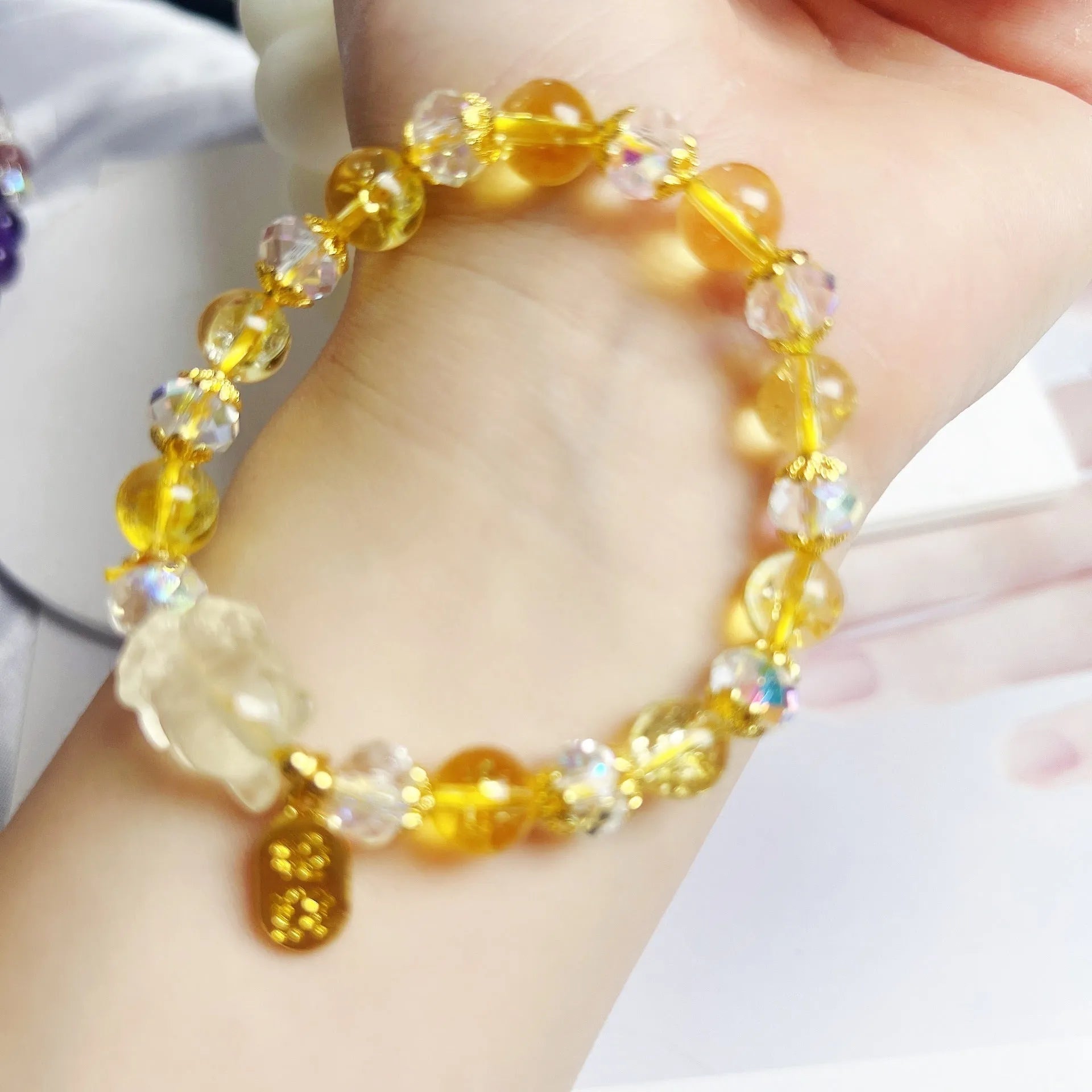 Natural citrine nine-tail fox crystal bracelet for women on a wrist.