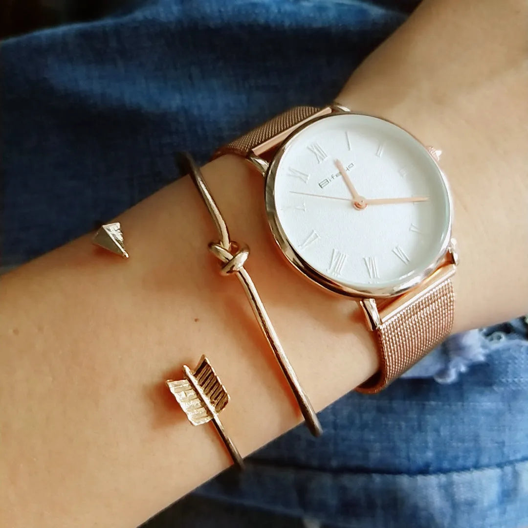 Gold women's vintage bracelet with knotted cuff design and central arrow motif