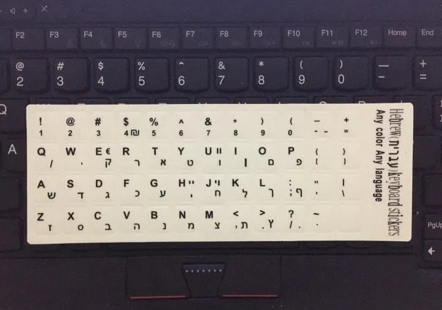 Yellow glowing keyboard stickers showing Arabic, Thai, Hebrew, French, Italian and German characters on PVC sheet