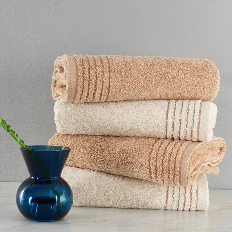 Cotton towel set showing beige and brown options with 34cm and 70cm sizes