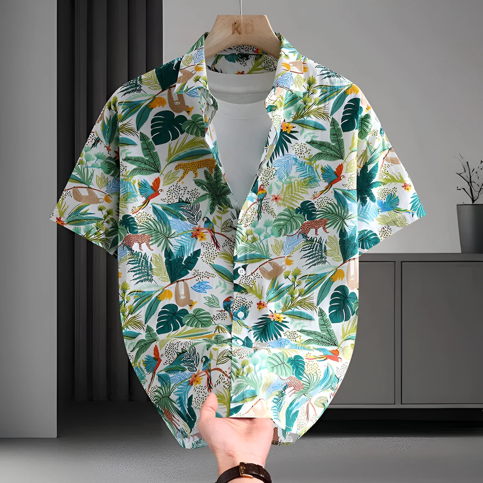 Men's short sleeve cotton shirt with colourful Hawaiian floral print, cardigan style, on a hanger.