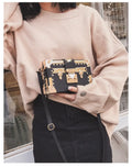 Black structured women's shoulder bag with flap and single strap.