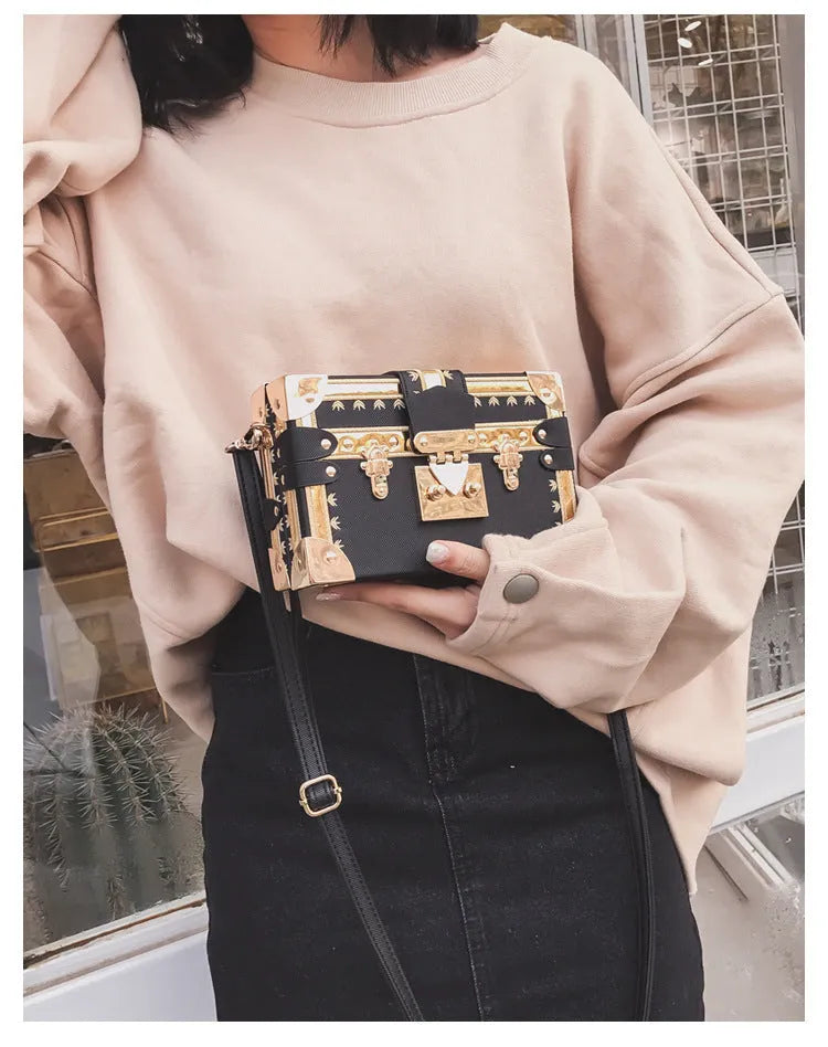 Black structured women's shoulder bag with flap and single strap.