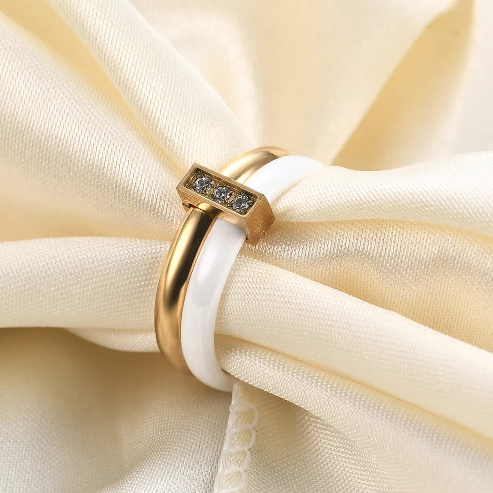 Glossy black ceramic women's ring with round zirconium stones on a geometric 6mm band.