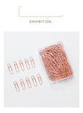 Rose gold heart-shaped metal paper clips in a box, size 28mm.