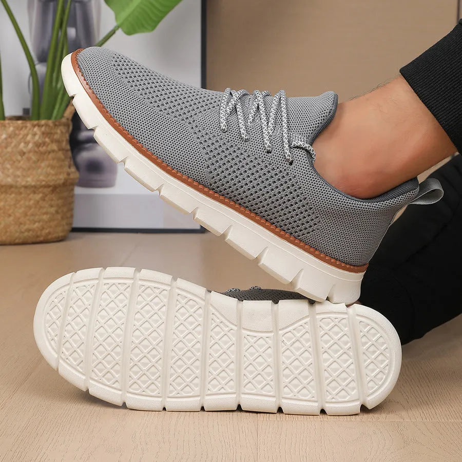 Men's grey mesh casual sneakers with round toe and low-cut design on a white background.
