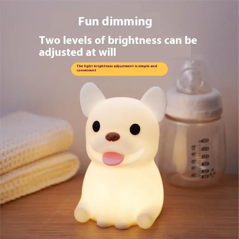 Cartoon animal silicone USB night light with dimmer switch on a bedside table.