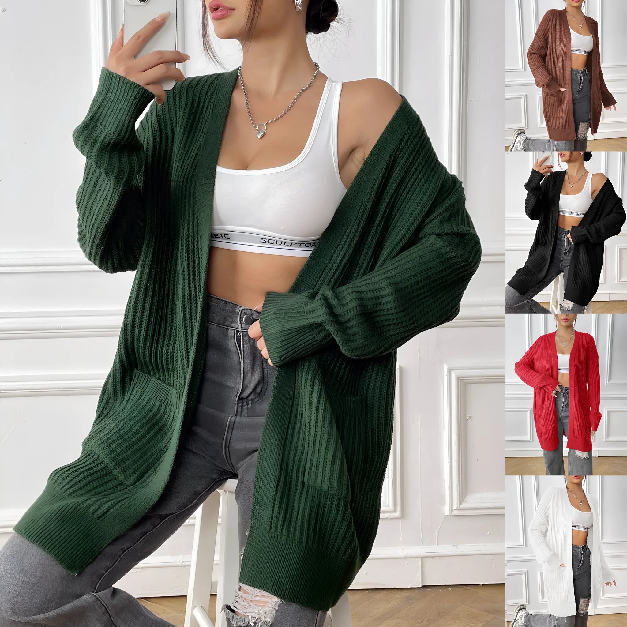 A woman's loose-fit acrylic cardigan in dark green with long sleeves and two front pockets.