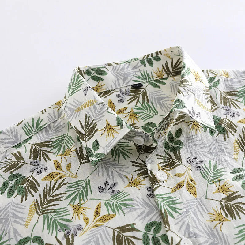 Men's short sleeve cotton shirt with colourful Hawaiian floral print, cardigan style, on a hanger.