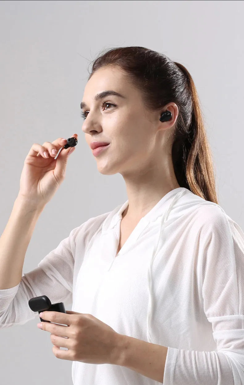 Pearl white and black true wireless Bluetooth sports headphones with in-ear design.