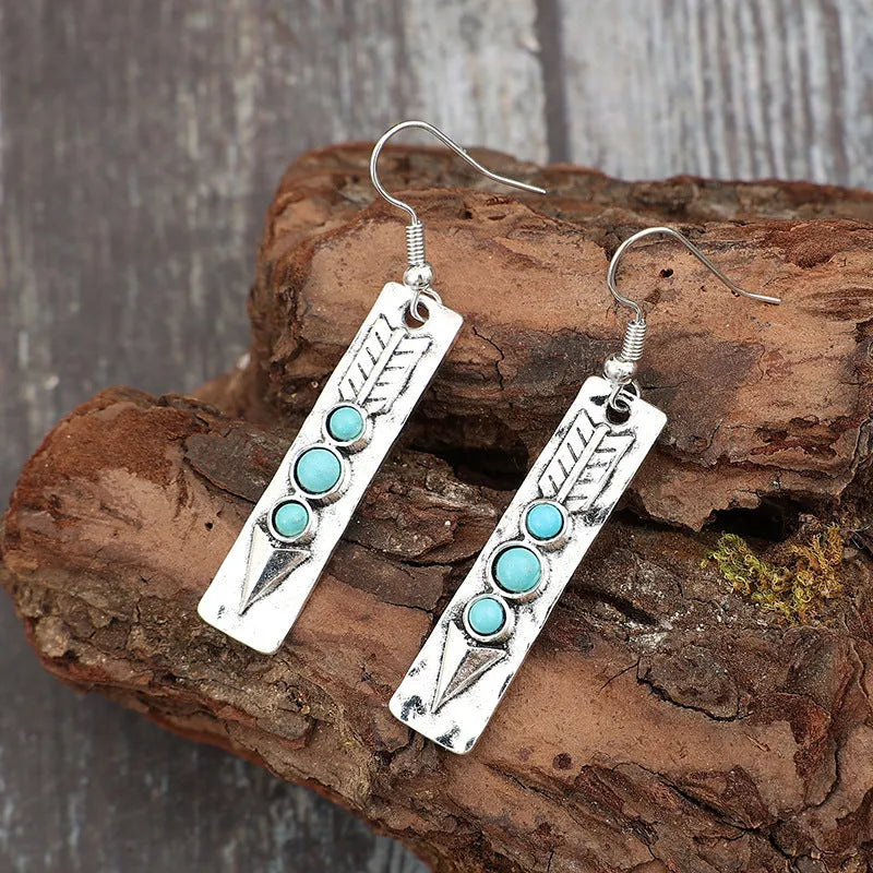 Silver geometric retro earrings with inlaid turquoise detail on zinc alloy