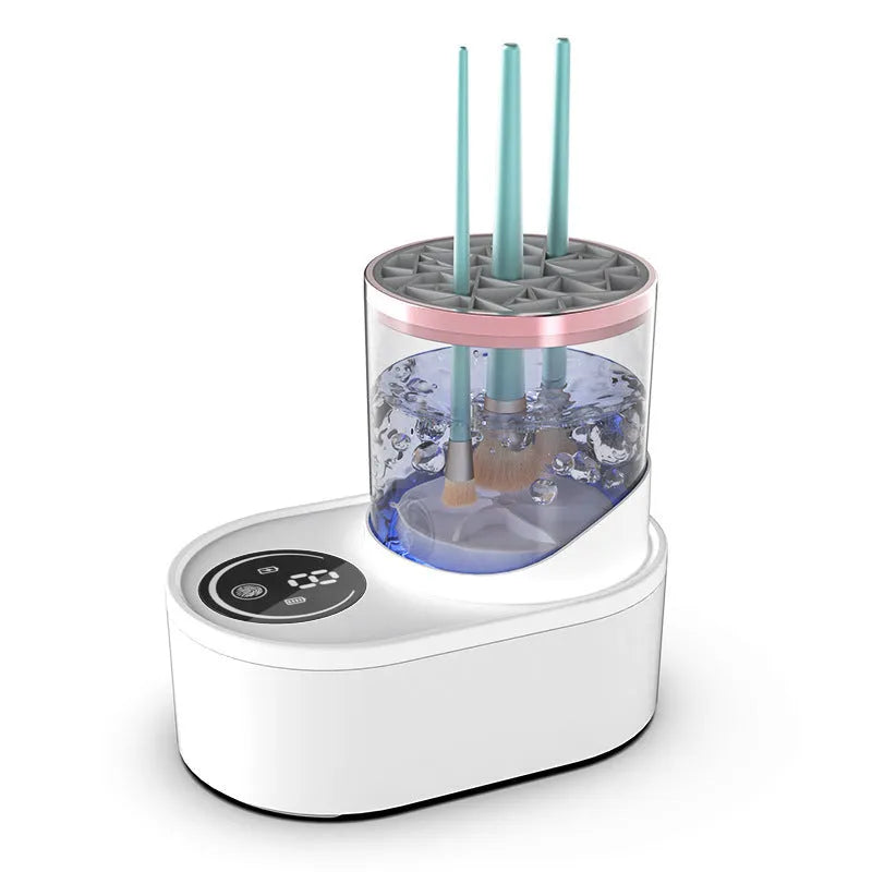 White rechargeable electric makeup brush cleaner with drying chamber on a vanity table.