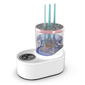 White rechargeable electric makeup brush cleaner with drying chamber on a vanity table.