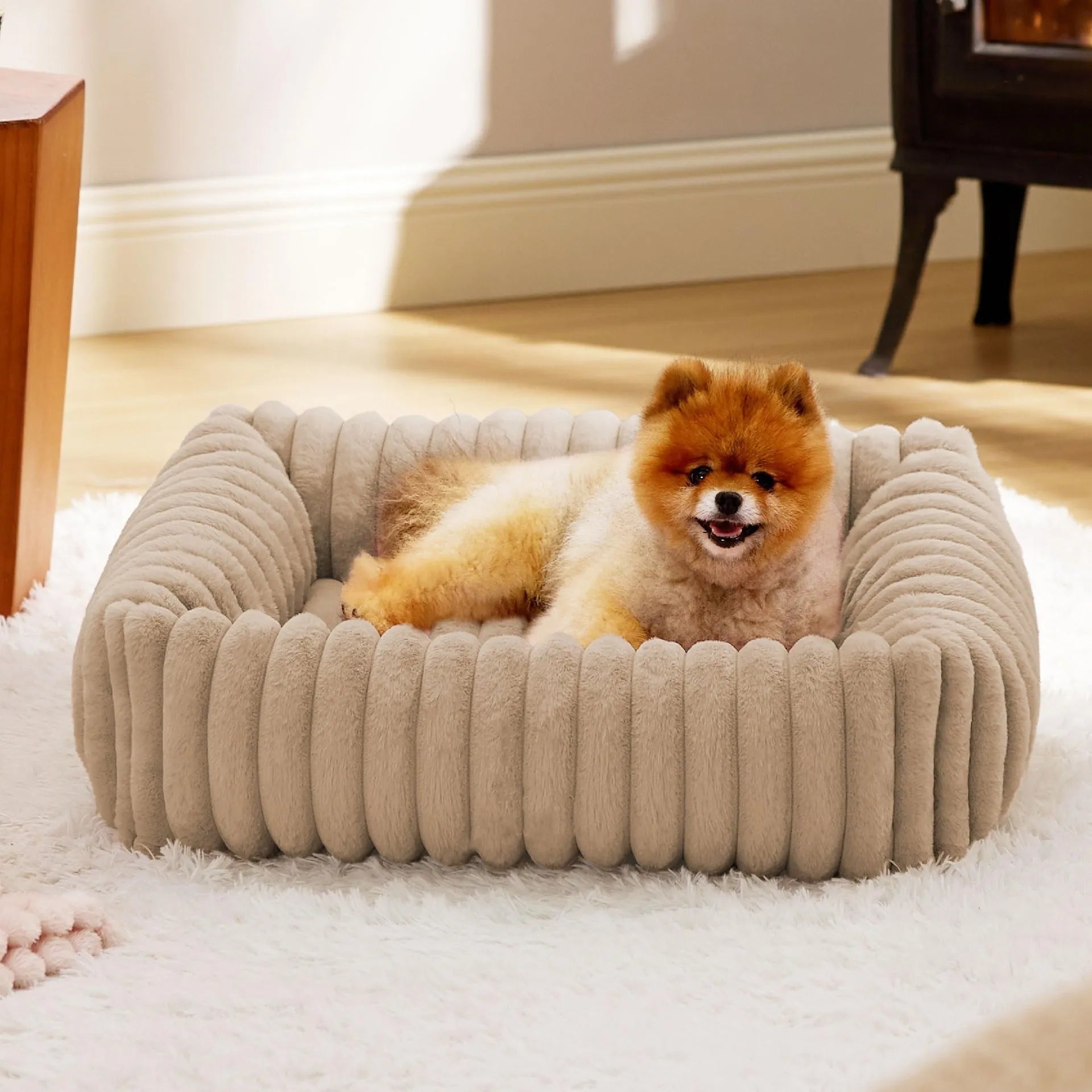 A raised winter pet bed for cats or dogs with a soft cushion, shown in a neutral colour.